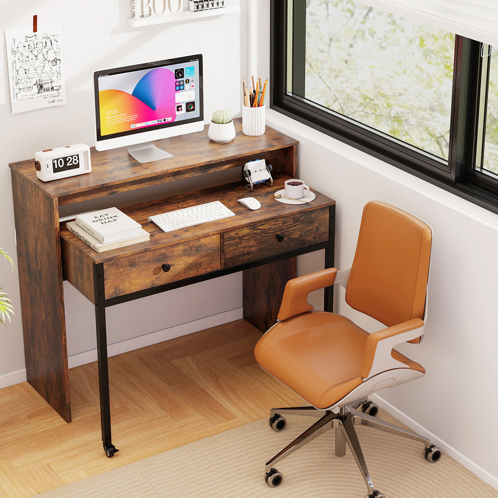 Extendable computer desk in rustic brown with two storage drawers, monitor shelf, and rolling wheels for versatile use.