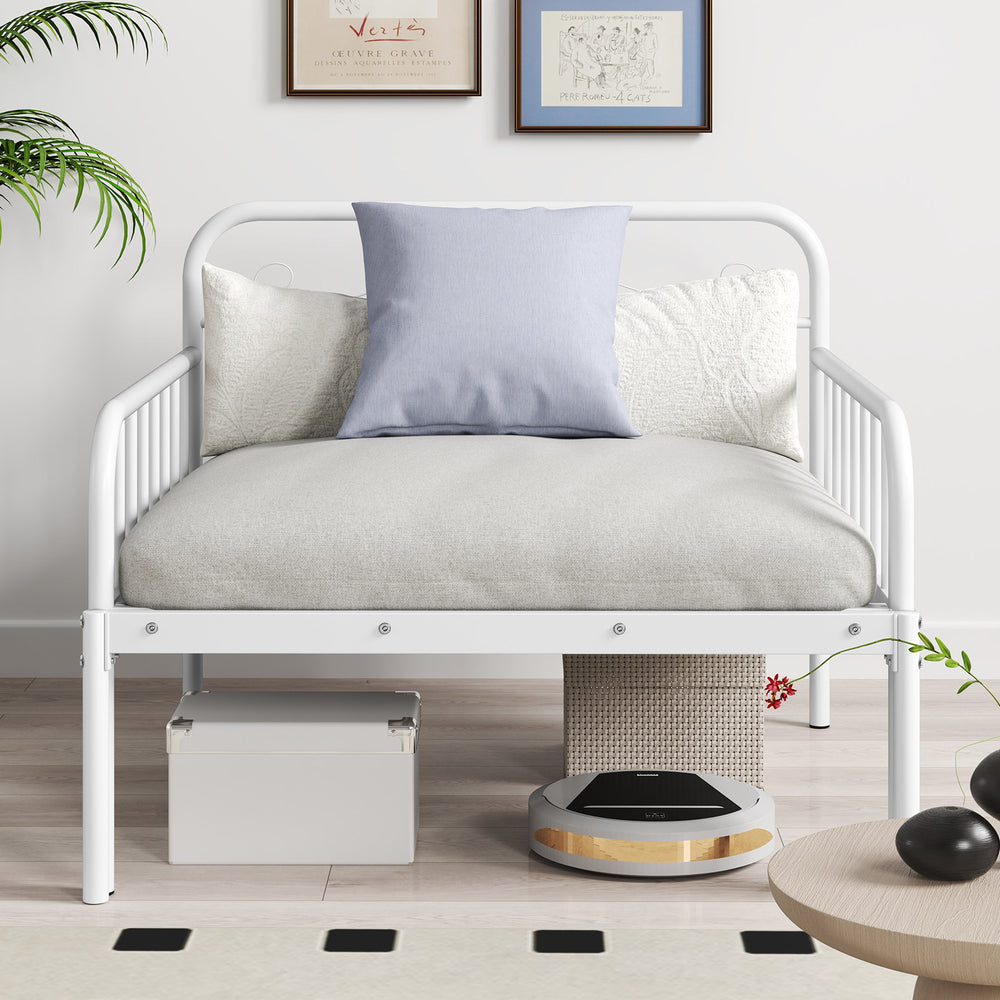White extendable metal daybed with guardrails and armrests, perfect for relaxation and extra sleeping space.