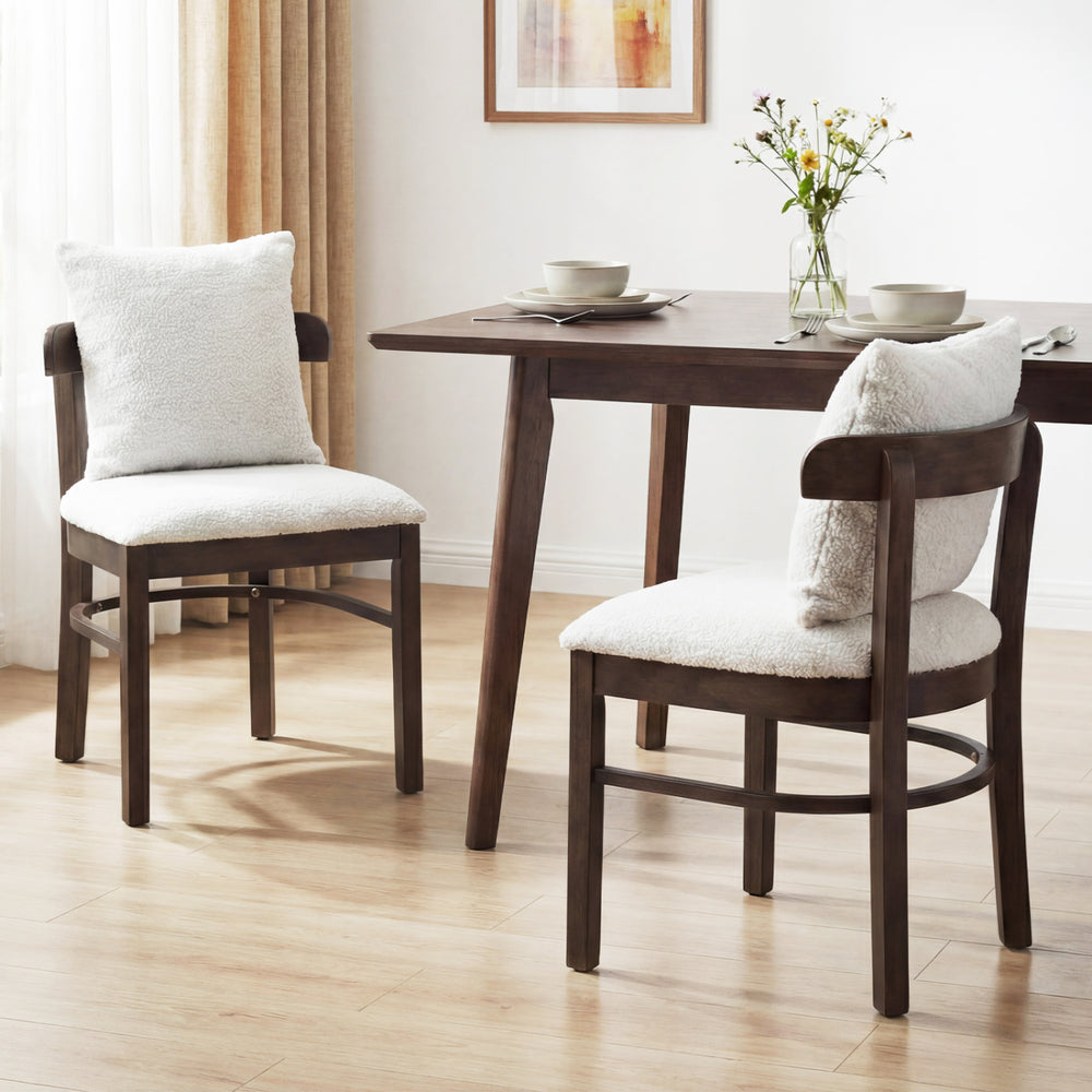 Gray fabric upholstered dining chairs set with removable pillows, featuring solid wood legs and a supportive curved.