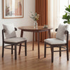 Two gray fabric upholstered dining chairs with removable pillows, featuring solid rubber wood legs, for comfortable.