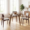 Round walnut dining table for 4 with rubber wood legs, featuring a smooth surface and vintage design, ideal for cozy.