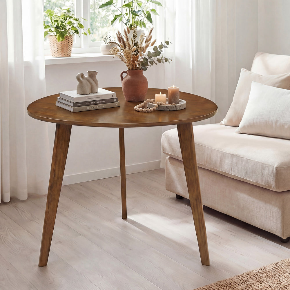 Round walnut dining table for 4 with rubber wood legs, featuring a smooth surface and vintage design, perfect for cozy.