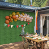Artificial boxwood wall panels with vibrant balloons and bunting, perfect for outdoor party decoration and easy to.