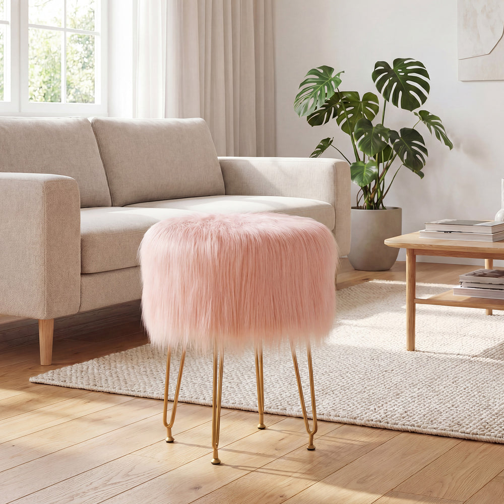 Pink faux fur vanity stool with metal legs, perfect for bedroom or living room decor and comfortable seating.