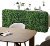 Faux greenery room divider hedge wall in a living room, made of durable PE material for stylish privacy and decor.