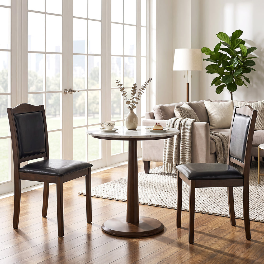 Two walnut wooden farmhouse dining chairs with faux leather upholstery, featuring comfortable padding for dining spaces.