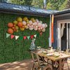 Artificial topiary gardenia shrub grass panels displayed on a wall, perfect for outdoor party decoration and.