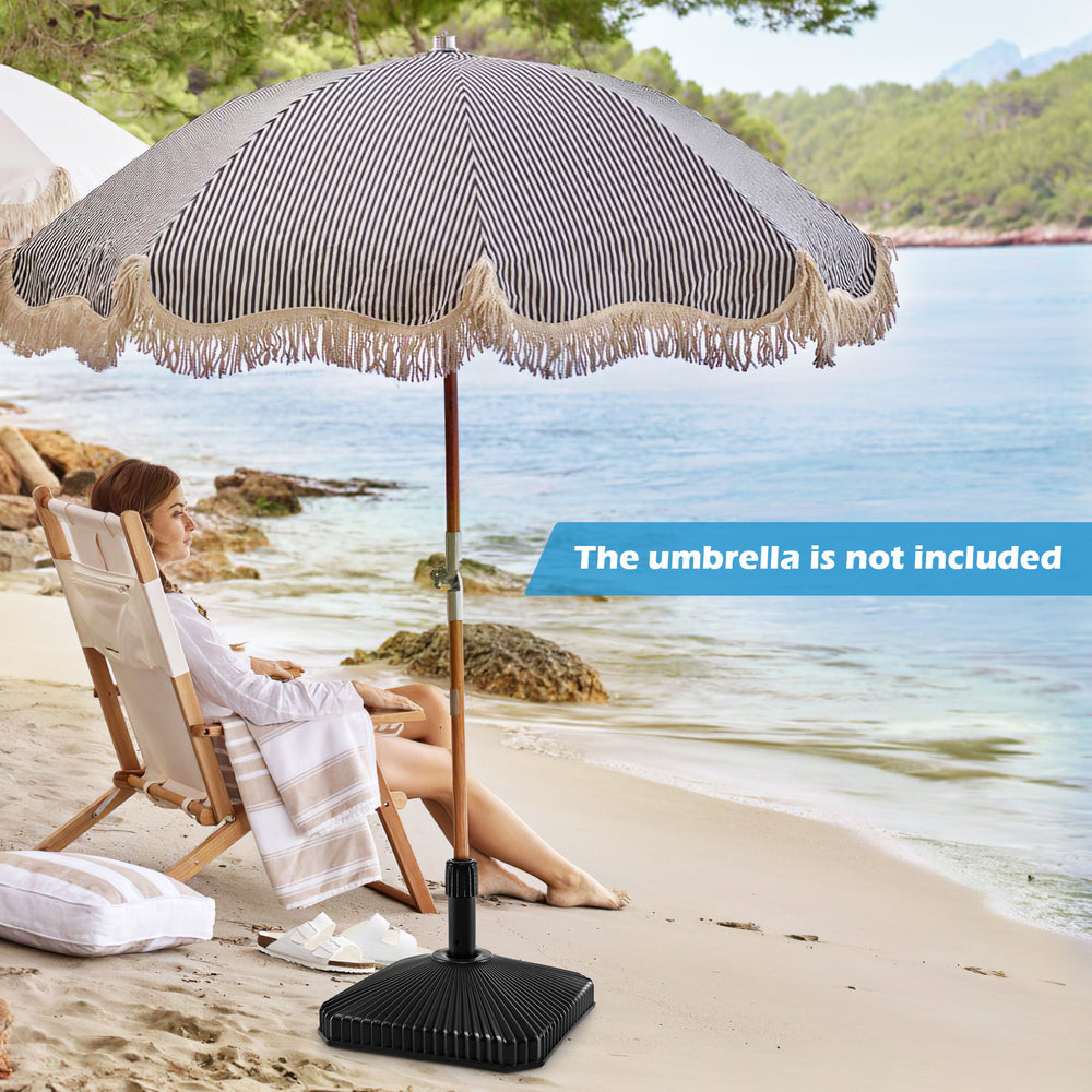 Fillable umbrella base in black with shell texture, designed for 6-10 ft patio umbrellas, providing stability on the.