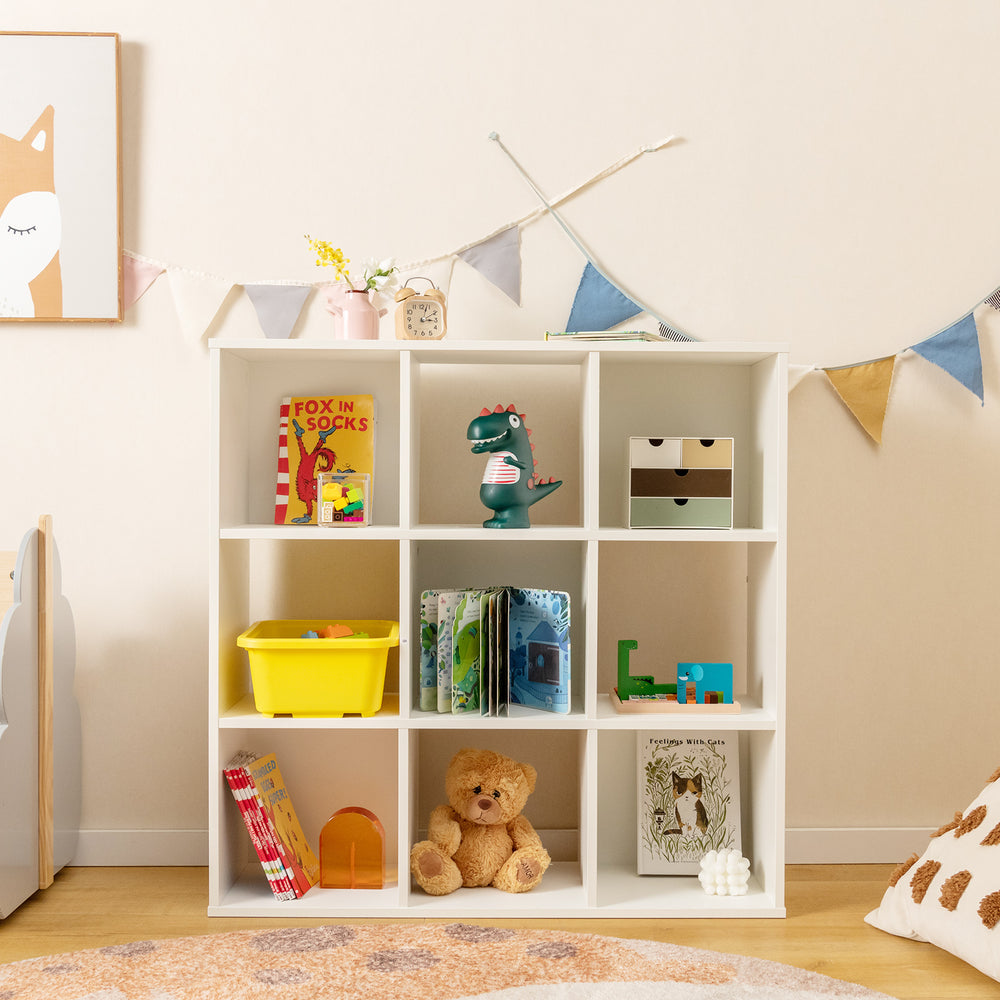 Wooden kids bookcase with storage cubbies in white, featuring toys and books, ideal for organizing in children's rooms.