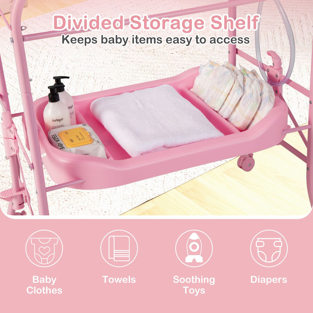 Pink foldable diaper changing table on wheels with bathtub, storage shelf, and changing pad for infant care