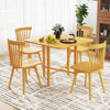 Foldable dining table with rubber wood legs, featuring drop leaf panels, set for four in a bright, modern space.