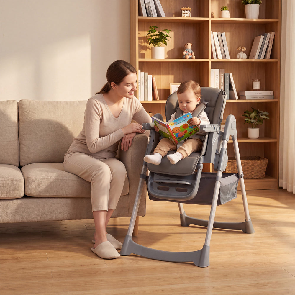 Foldable high chair for babies and toddlers in gray, featuring adjustable height, removable tray, and padded seat cushion.