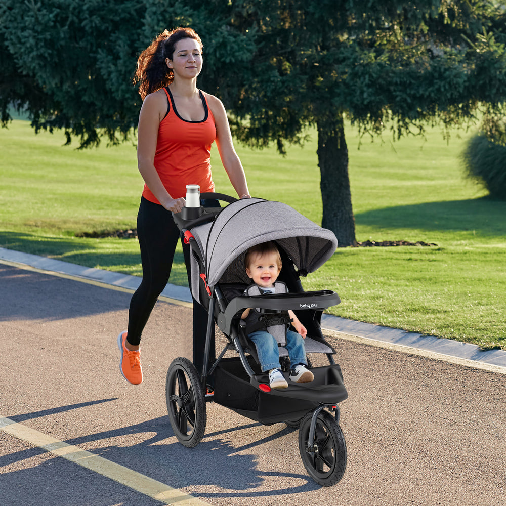 Jogging stroller in gray with air-filled rubber tires, adjustable canopy, and detachable tray for active parents and.