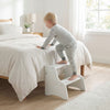 Foldable white toddler step stool with chalkboards, ideal for kids to reach heights safely and creatively.