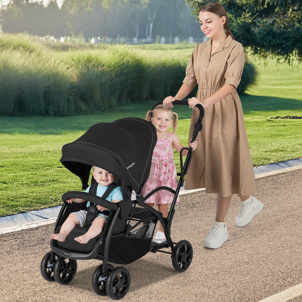 Foldable twin tandem stroller in black with adjustable handlebar, accommodating two kids for convenient outings.