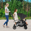 Foldable twin tandem stroller in black with adjustable handlebar, suitable for younger and older kids, for outdoor use.