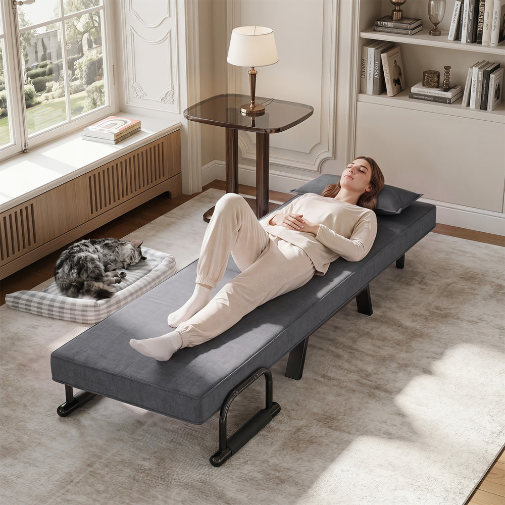 Convertible sleeper bed in gray with adjustable backrest, soft pillow, and armrests, perfect for relaxing in any room.