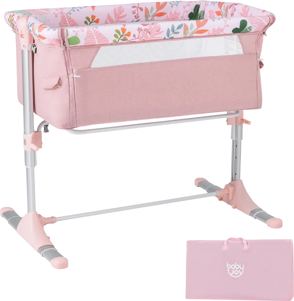 Folding baby bassinet bedside sleeper in pink with adjustable height, detachable side rail, and included carry bag.