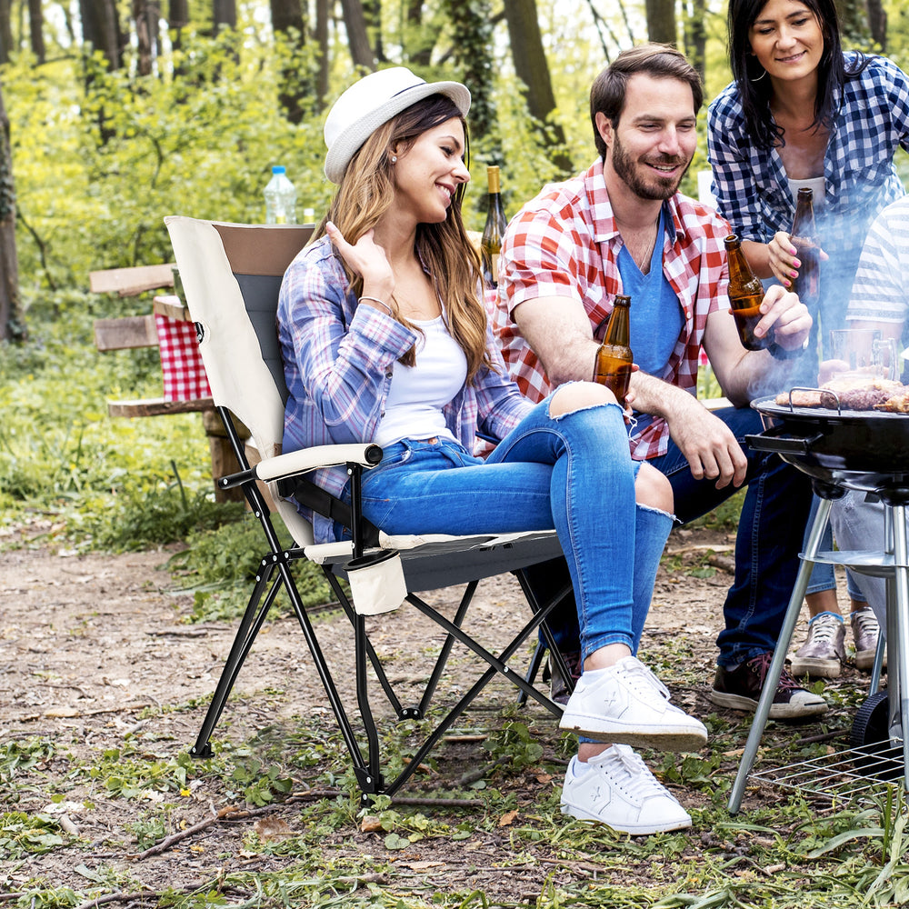 Folding camping chair with cup holder and lumbar pillow, designed for comfort and stability during outdoor gatherings.