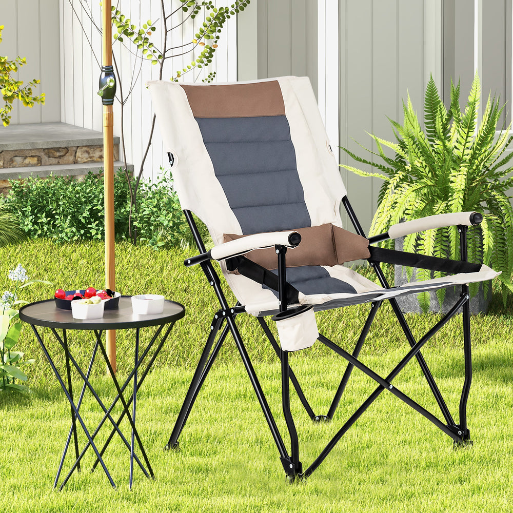Folding camping chair with cup holder armrest and lumbar pillow, featuring breathable fabric and sturdy metal frame.