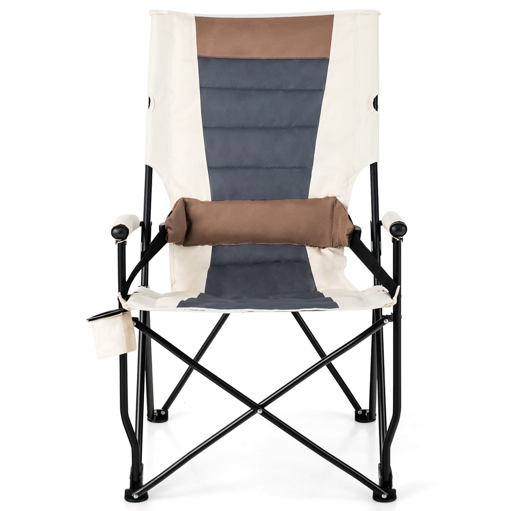 Folding camping chair with cup holder armrest, lumbar pillow, and sturdy metal frame for outdoor convenience.