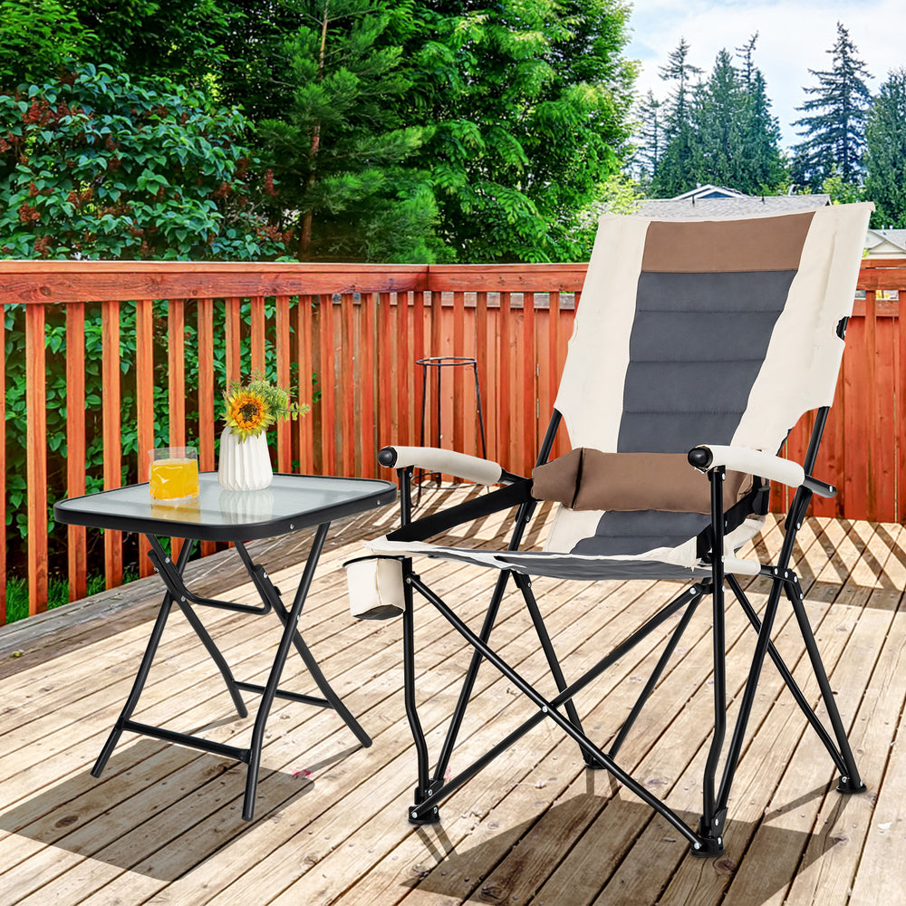 Folding camping chair with cup holder and lumbar pillow, featuring breathable fabric, on a wooden deck for outdoor.