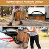 Folding camping table with adjustable heights, black and brown finish, featuring a practical handle for easy transport.