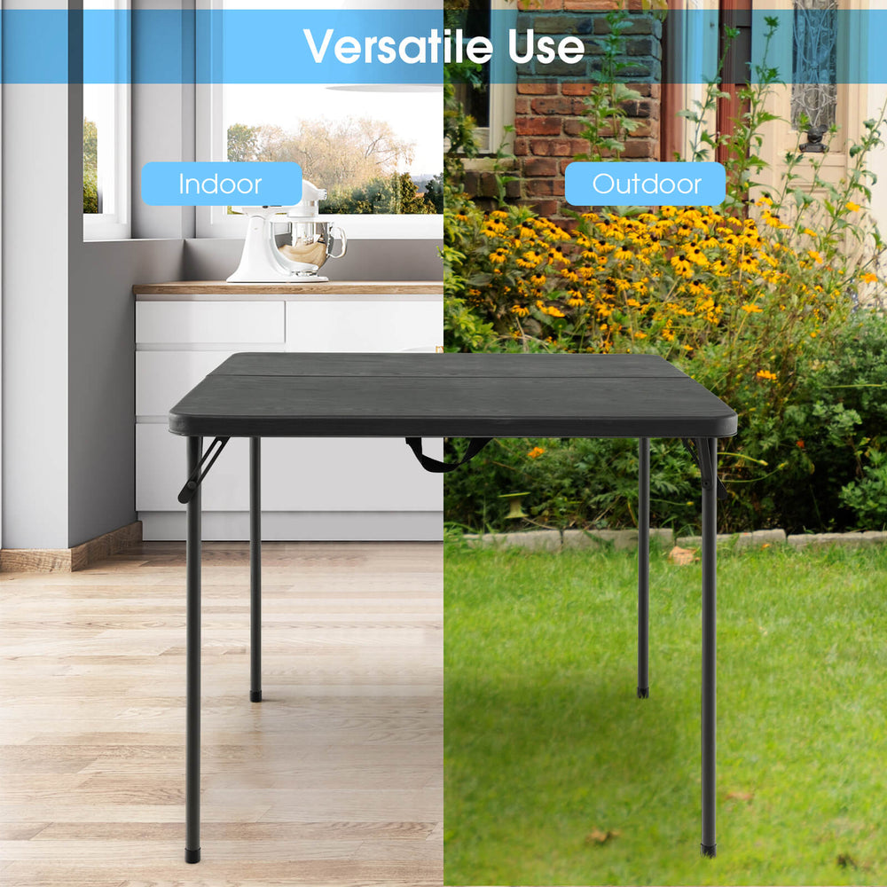 Folding camping table with gray all-weather HDPE tabletop and rustproof steel frame, ideal for indoor and outdoor use.