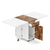 Folding dining table with drop leaf design, brown wood-like texture, and lockable wheels for versatile kitchen use.