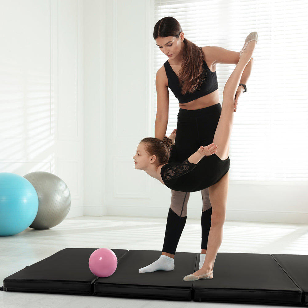 Folding gymnastics mat in black with a durable PU leather cover, ideal for yoga and stretching exercises.