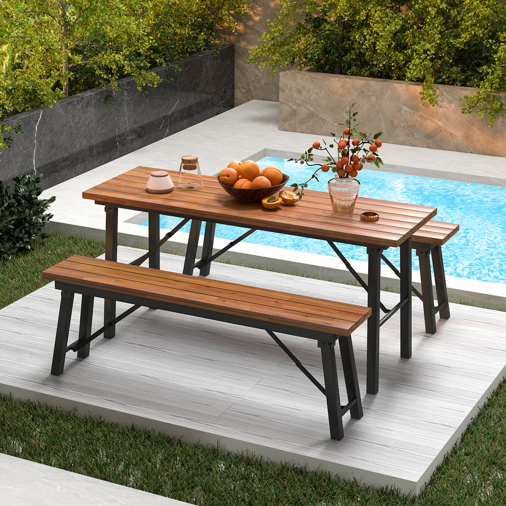 Rectangular folding picnic bench set made of acacia wood, perfect for outdoor dining by the poolside.