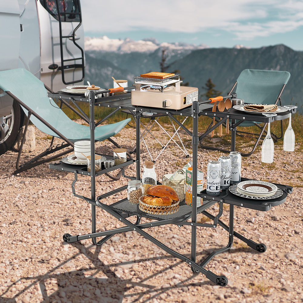 Folding portable outdoor cook station with heat-resistant aluminum tabletop, featuring side tables and storage for.