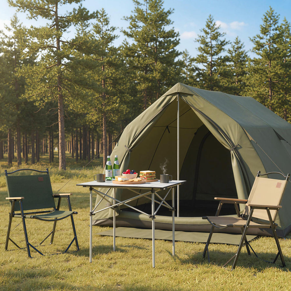 Folding roll-up camping table with metal legs set up outdoors, featuring an all-weather aluminum top for versatile use.