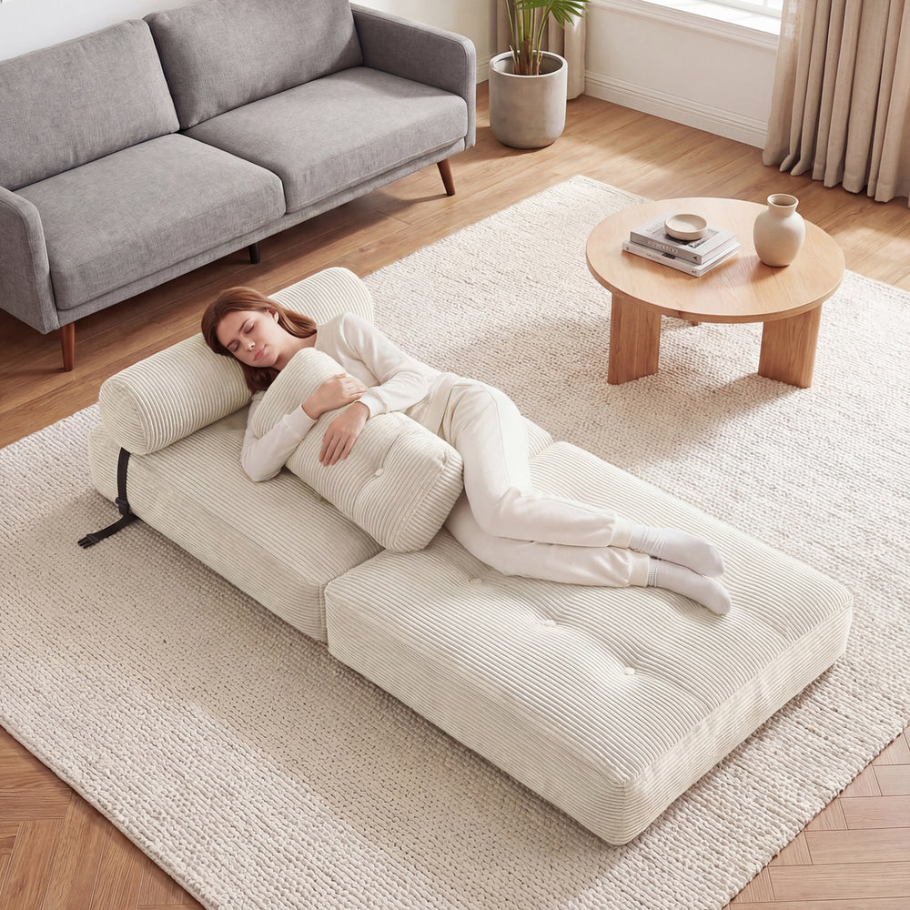 Folding sofa bed in beige with back support and pillow, perfect for lounging or sleeping in living rooms or guest rooms.