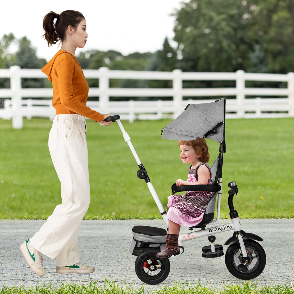 Folding tricycle baby stroller in gray with adjustable canopy and reversible seat, perfect for outdoor walks.