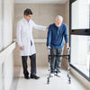 Height adjustable aluminum walker with rolling wheels and brakes, shown in use for mobility support and stability.