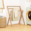 Freestanding foldable teak wood towel rack showcasing its natural texture, perfect for stylish towel organization.