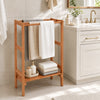 Freestanding towel rack made of solid wood with three hanging bars and a bottom shelf for additional storage in the bathroom.