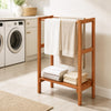 Freestanding towel rack showcasing a smooth wood surface with three hanging bars and a sturdy bottom shelf for towels.
