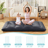 Full-size futon mattress with washable cover, ideal for yoga, camping, or as a kid's play mat, shown in a living room.