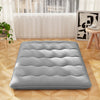 Full-size futon mattress in grey with quilted design, machine washable cover, ideal for camping or as a sleeping pad.