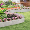 Galvanized metal landscape edging in a garden, creating custom shapes and borders for flower beds and lawns.