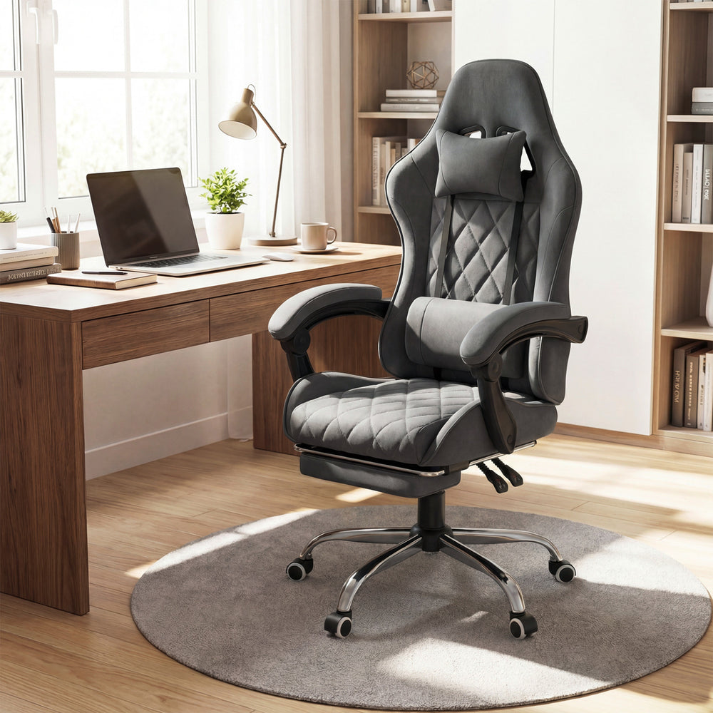 Height adjustable gray gaming chair with headrest and lumbar support, designed for comfort during long gaming sessions.