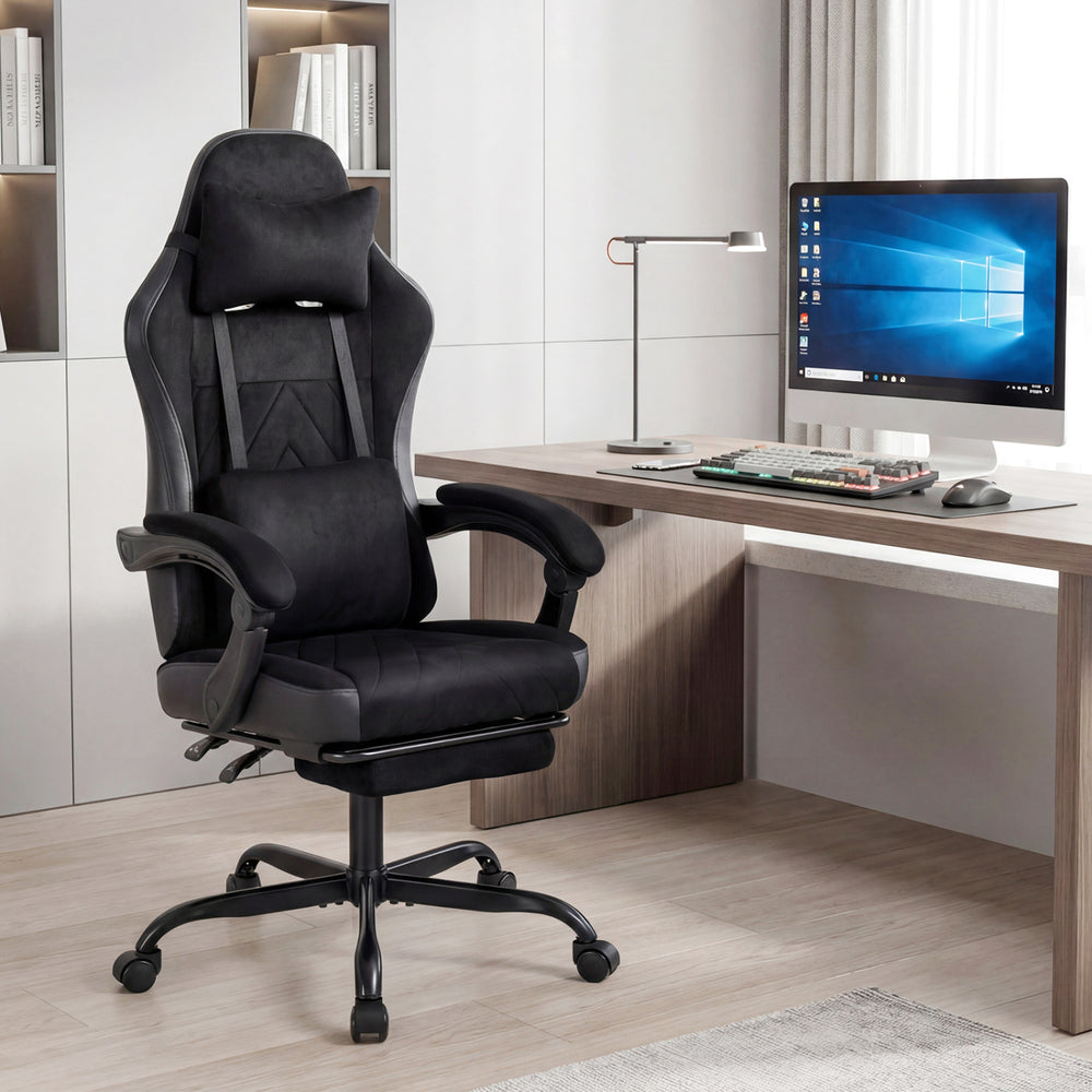 Height adjustable black gaming chair with ergonomic design, headrest, lumbar support, and retractable footrest for.