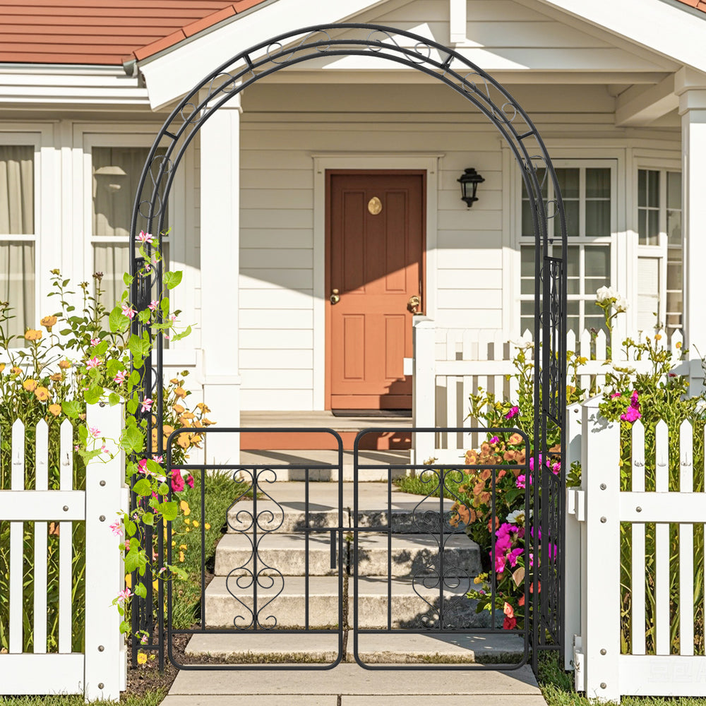 Black garden arbor with gate featuring multiple crossbars, ideal for climbing plants and elegant outdoor decor.