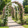 Heavy-duty metal garden arch trellis with pink and white flowers, perfect for climbing plants in outdoor pathways.