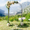 Garden arch arbor trellis in black with floral decorations, ideal for outdoor weddings and climbing plants.