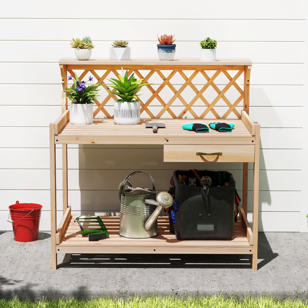 Wooden garden potting bench with lattice trellis, spacious countertop, slide-out drawer, and ample storage for.