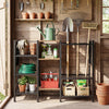 Garden tool organizer with wooden shelves, featuring a black metal frame and open-access design for efficient storage.