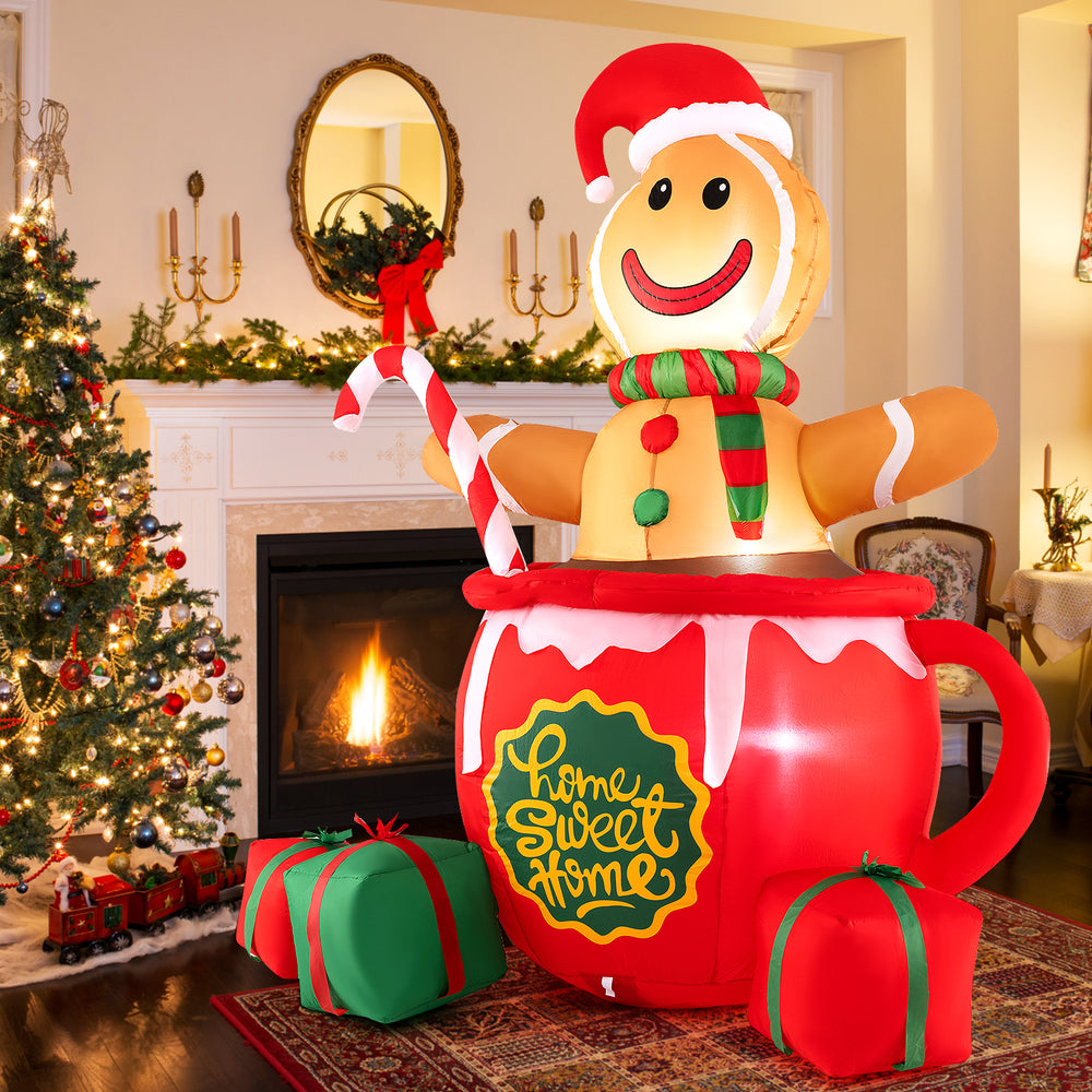 7-foot inflatable gingerbread man in a hot cocoa mug with Santa hat and candy, ideal for cheerful holiday garden decor.